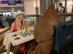 Cowboy-hat Barbie playing the Chess Jawa.