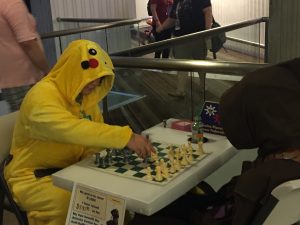 The chess jawa playing someone in a Pikachu onesie